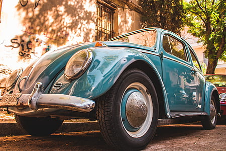blue Volkswagen Beetle Type 1 parked beside the street thumbnail