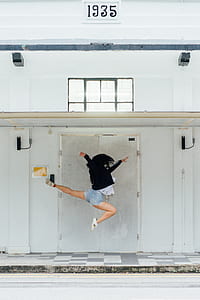 woman jumping near french door at room 1935 thumbnail