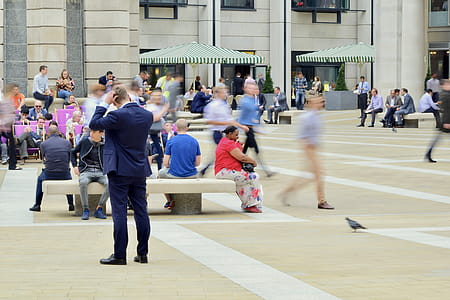 Man Wearing Blue Suit on Beige Ground Near Building thumbnail
