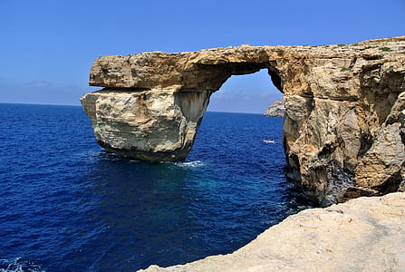 clear sky over body of water and cliff thumbnail