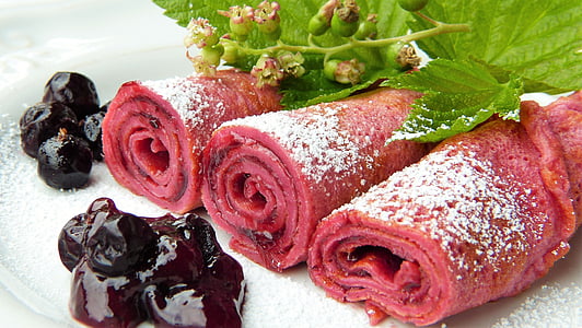 selective focus photo of swiss roll top with powered sugar and black berries thumbnail