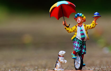shallow focus photography of clown and dog figurines thumbnail