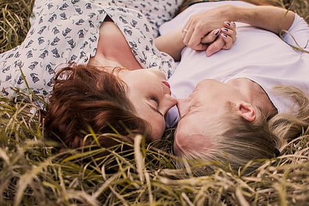 two woman lying on green grasses thumbnail