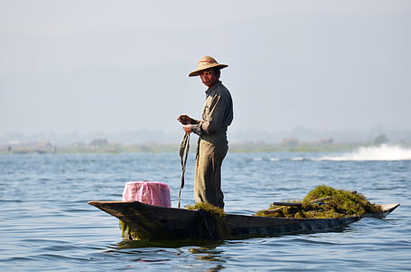 man standing on boat near body of water during daytime thumbnail