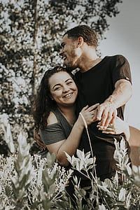 couple hugging each other surrounded with plants thumbnail