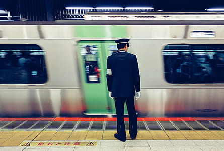 train attendant standing near train entrance thumbnail