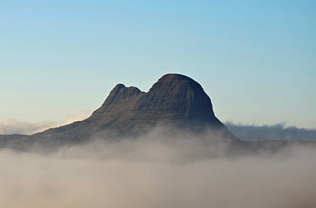 brown mountain covered with clouds thumbnail