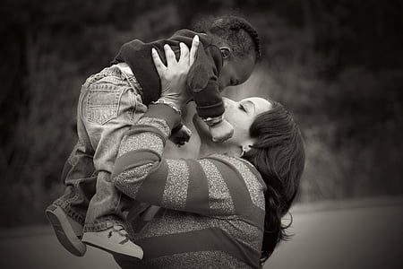 woman holding baby up high thumbnail