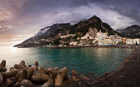 landscape photography of houses on mountain near body of water thumbnail