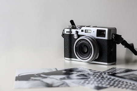 black and gray DSLR camera on white surface thumbnail