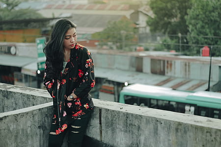 woman sitting on top of building thumbnail