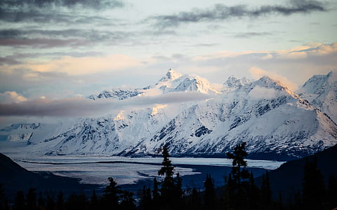 snow covered mountain near trees thumbnail