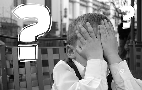 gray scale photo of boy wearing white dress shirt covering his face thumbnail