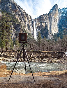 brown lamp on tripod near waterfalls thumbnail