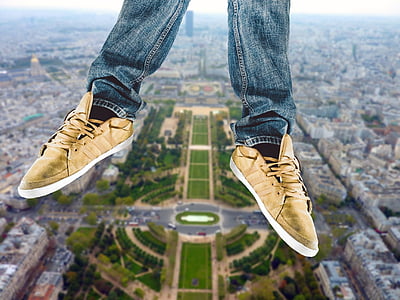selective focus photo of person's feet wearing brown low-top sneakers thumbnail