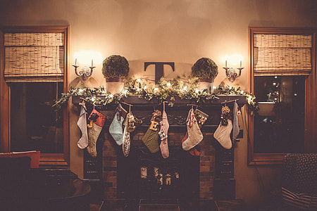 socks hanged above fireplace with string lights thumbnail