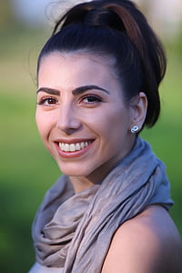 woman wearing gray scarf smiling thumbnail