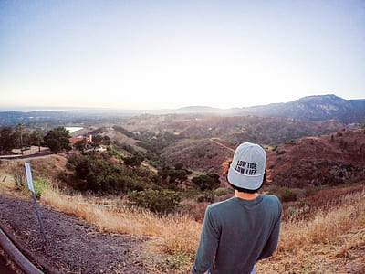 person standing on side of the road near cliff thumbnail