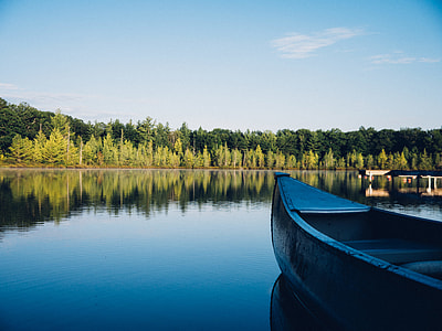 blue boat on body of water thumbnail