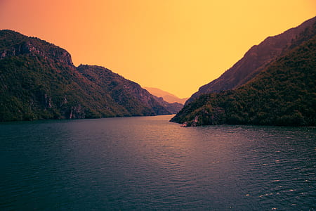 green mountain hill beside blue sea thumbnail
