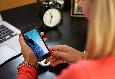 woman holding black smartphone thumbnail