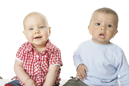 baby wearing blue long-sleeved crew-neck shirt sitting beside baby wearing red and white checkered button-up shirt thumbnail