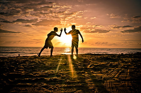 silhouette of people near body of water during sunset thumbnail
