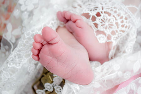 white lace cloth worn by baby thumbnail