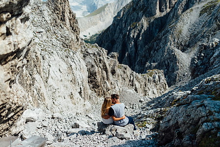 couple sitting on mountain cliff thumbnail