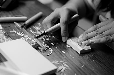 Grayscale Photo of Person Carving Block thumbnail