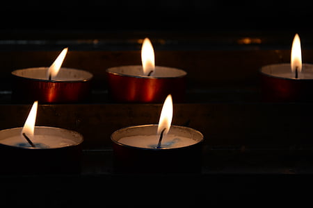 five lighted tealight candles thumbnail