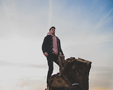 man standing on tree trunk thumbnail