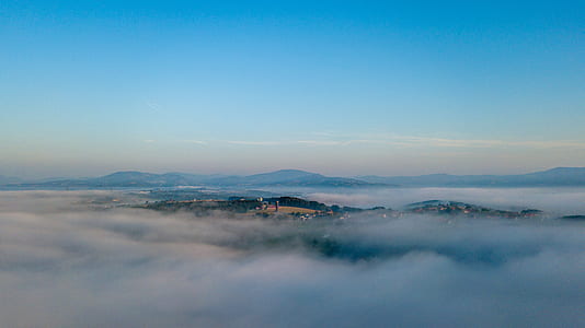 aerial photo of buildings covered in mist thumbnail