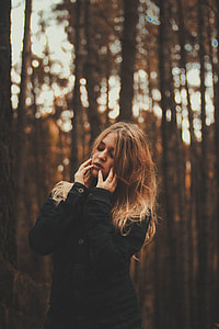 photo of woman holding her face with her two hands outdoors thumbnail