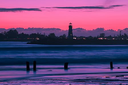 silhouette photography of lighthouse thumbnail