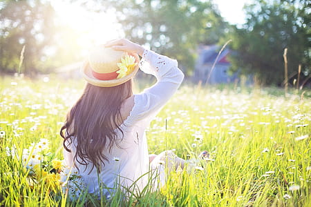 woman sitting facing backward wearing hat thumbnail