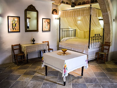 rectangular table near black canopy bed thumbnail
