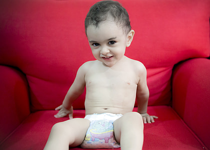 child sitting on red armchair thumbnail