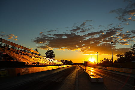 grand stand bleachers near road during golden hour thumbnail