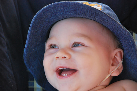 smiling baby wearing blue hat thumbnail