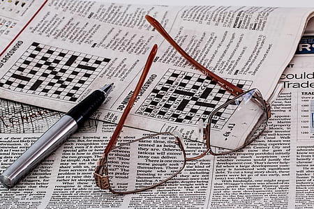 silver-colored framed eyeglasses beside ballpoint pen thumbnail