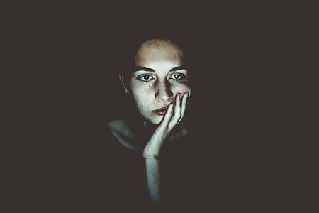 woman touching face with left hand thumbnail