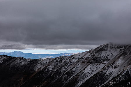 snow covered mountain under clouds thumbnail