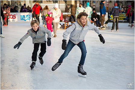 two boys playing ice skates thumbnail