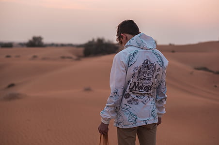 man standing in the middle of the desert thumbnail