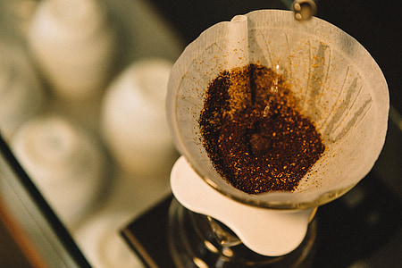 close-up photography of brown coffee powder on beige strainer thumbnail