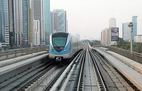 gray and blue train near high rise buildings at daytime thumbnail