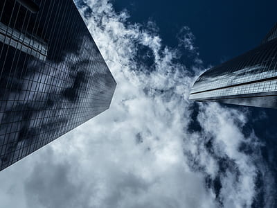 low angle photograph of building and clouds thumbnail