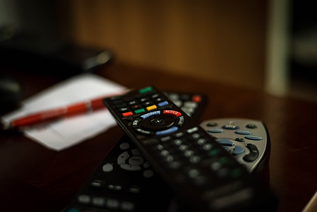 shallow focus photography of black remote controls thumbnail