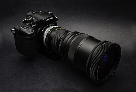 black Lumix DSLR camera on black surface thumbnail